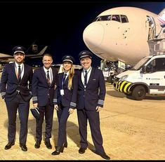 three pilots standing in front of an airplane