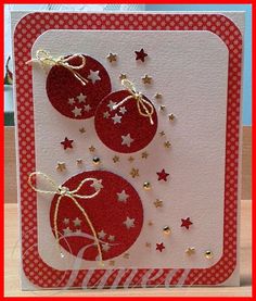 a red and white card with two ornaments on it