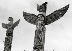 three totems are standing in the snow with their arms spread out and two birds perched on them