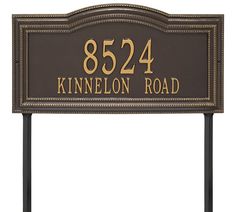 a brown sign with gold lettering on the front and back of it that says 822 kennelon road