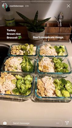 four glass containers filled with food sitting on top of a counter