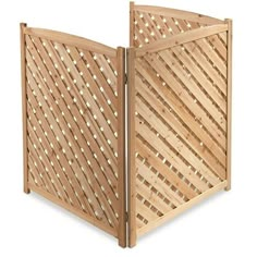 a wooden gate with lattice design on the top and bottom panel, open to reveal an opening