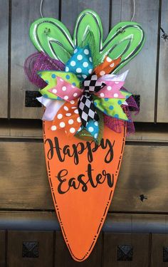 a sign that says happy easter hanging on a door hanger in front of a wooden door