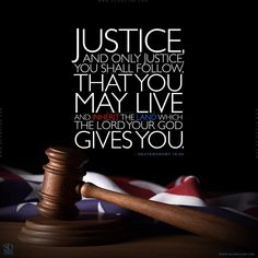 a wooden gavel sitting on top of a table with an american flag in the background