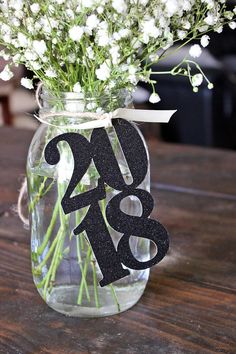 a vase filled with flowers on top of a wooden table