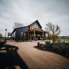 a large house with lots of windows and landscaping