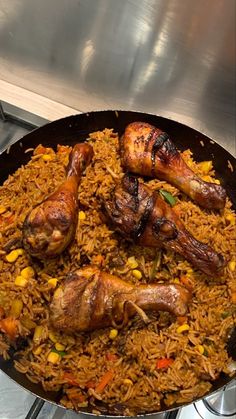 a pan filled with chicken and rice on top of a stove