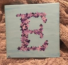 the letter e is made up of pink and purple flowers