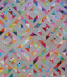 a quilt made with different colors and shapes