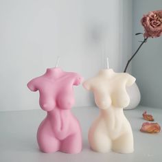 two small candles sitting next to each other on a table