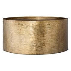 a gold metal bowl on a white background, with no one in the photo looking at it