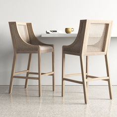 two chairs sitting next to each other in front of a table