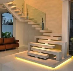 the stairs are lit up with leds in this modern living room, which also has an open floor plan