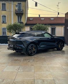 a black car parked in front of some buildings