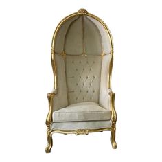 an ornate gold and white chair on a white background with the back upholstered