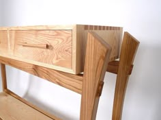 a wooden bench with two drawers on it