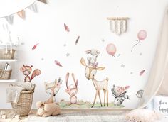 a child's room decorated in pink and white with deers, balloons and stars