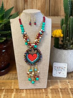 This beautiful Mexican jewelry is handmade by Mexican Artisans and completely one of a kind. The combination of pearls add a feminine touch to your outfit. The pendant is made of leather and hand painted. This jewelry is truly a work of art! The set includes a necklace and earrings. Mexican Folk Art Decor, Mexican Necklace, Multicolor Necklace, Mexican Jewelry, Traditional Earrings, Summer Attire, Unusual Jewelry, Fashion Jewelry Sets, Jewelry Lookbook