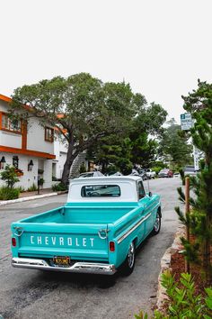 an old chevrolet truck parked on the side of the road