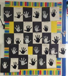 handprints are displayed on the wall in front of a checkerboard background