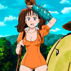 a woman in an orange bathing suit holding a water bottle over her head while standing next to a horse