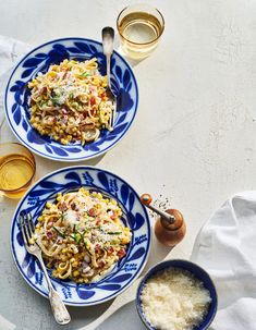 two blue and white plates topped with pasta