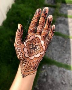 a person's hand with henna on it