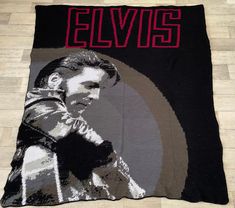 a blanket with elvis on it sitting on the floor