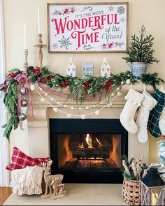 a fireplace decorated for christmas with stockings and stockings hanging from the mantel above it