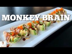 a white plate topped with lots of food on top of a wooden table and the words monkeyy brain