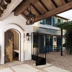 an outdoor patio area with potted plants and lanterns