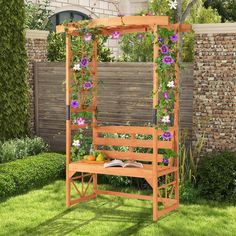 a wooden bench with flowers growing on it