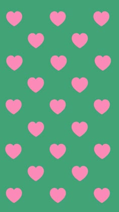 pink hearts are arranged on a green background