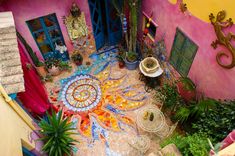 an aerial view of a colorfully decorated courtyard with potted plants and other decorations