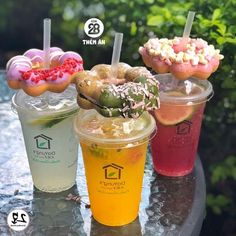 three different types of donuts and drinks on a table