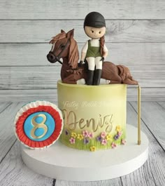 a birthday cake with a horse and rider on top