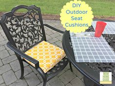 an outdoor seat cushion is sitting next to a table with a yellow and white napkin on it