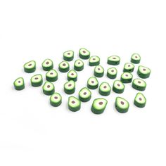 green and white ceramic beads on a white background