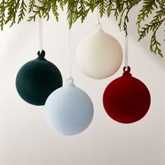 three ornaments hanging from a christmas tree