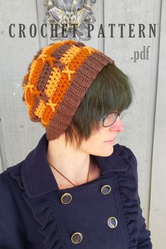 a woman with green hair wearing a brown and orange crocheted beanie hat