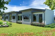 this is an artist's rendering of a small house in the grass with trees and flowers around it