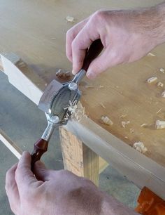 a person using a pair of pliers to cut wood with a circular sawtooth