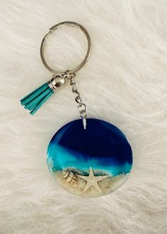 a blue and white keychain with a starfish on it