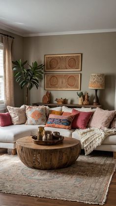 a living room filled with lots of furniture and pillows on top of a wooden table