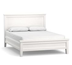 a white bed with two pillows on the headboard and one foot board is up