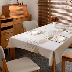 a dining room table with place settings on it