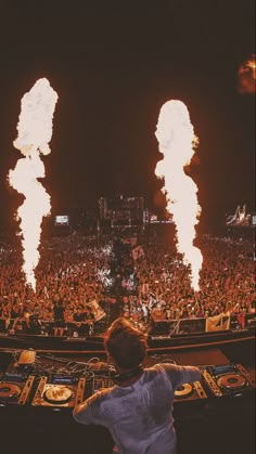 a man standing in front of a dj set on top of a stage