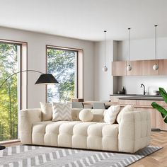 a living room filled with furniture next to windows and a rug on top of a hard wood floor