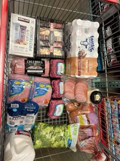 a grocery cart filled with meat and other items