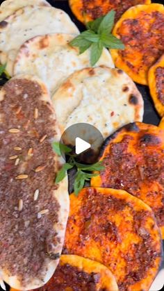 several different types of flat breads on a grill with herbs and seasoning sprinkles